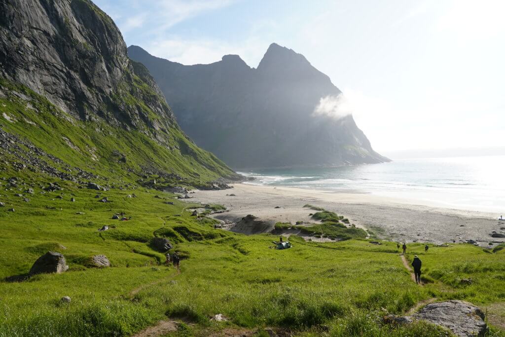 Huge granite cliffs overlooking a long sandy beach.